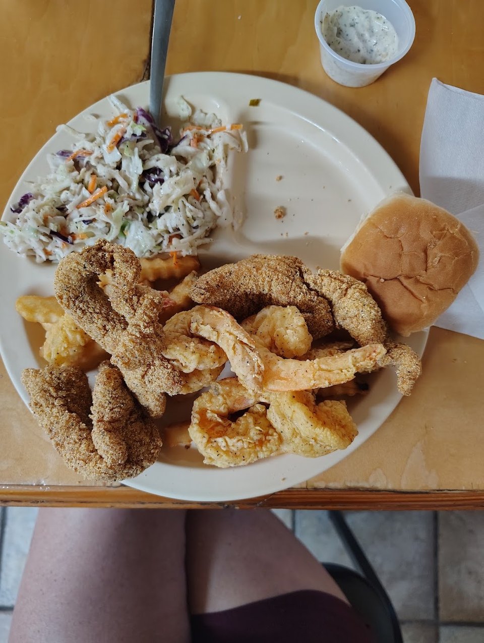 Cajun seafood plates on a plain restaurant table.